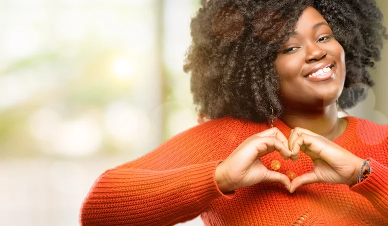 happy women making heart with hands