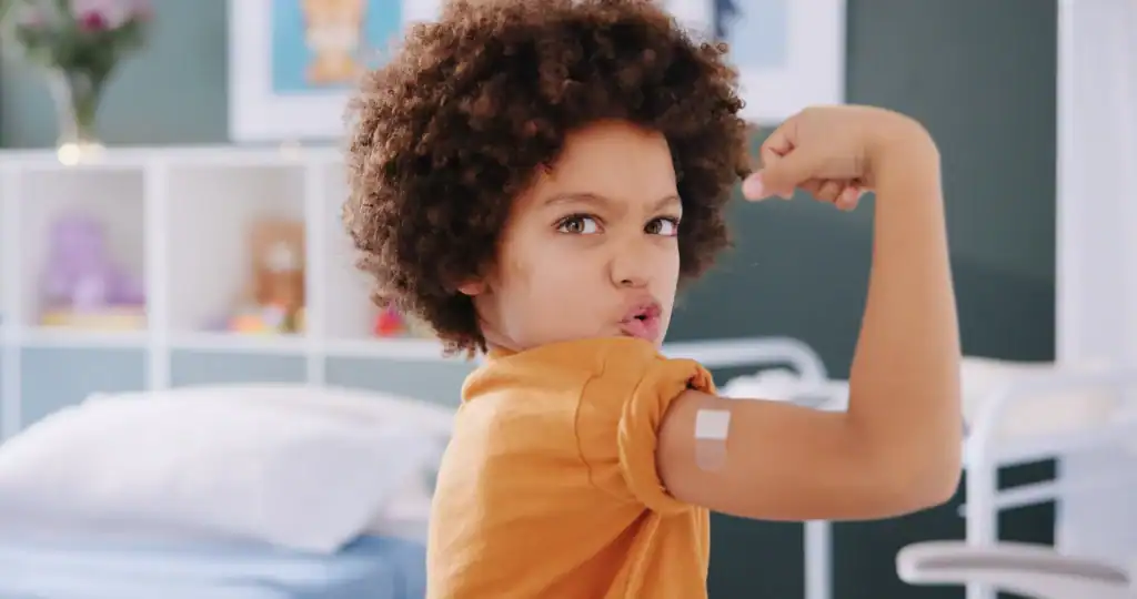 happy boy showing flu shot